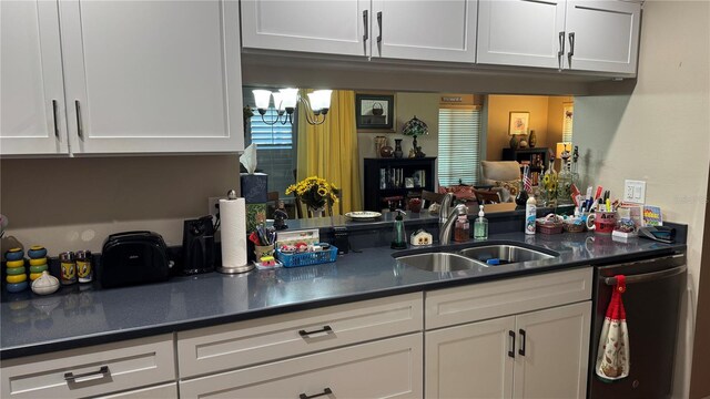 2841 74th St W Unit 2841, Bradenton, FL 34209 - kitchen with stainless steel dishwasher, white cabinetry, and dark countertops