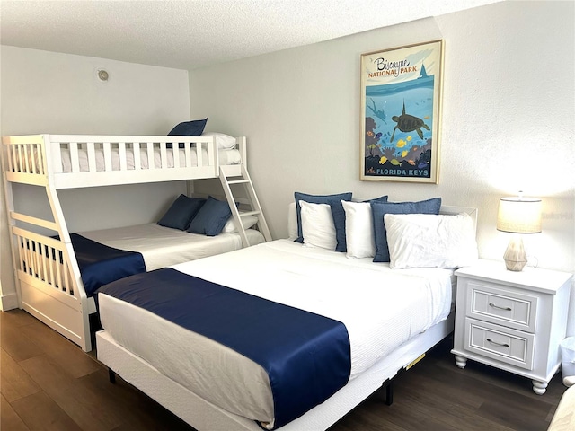 7150 N Tamiami Trl Unit C100, Sarasota, FL 34243 - bedroom featuring wood finished floors and a textured ceiling