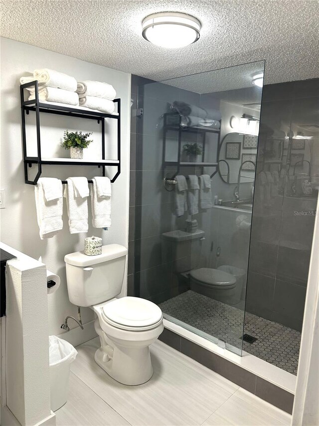 7150 N Tamiami Trl Unit C100, Sarasota, FL 34243 - full bath featuring toilet, a shower stall, and a textured ceiling