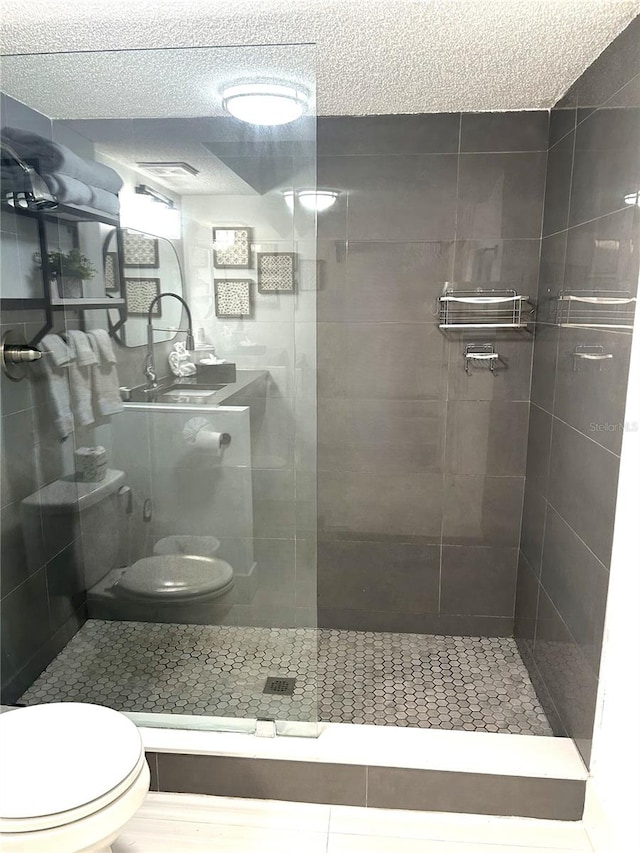 7150 N Tamiami Trl Unit C100, Sarasota, FL 34243 - full bathroom featuring toilet, walk in shower, and a textured ceiling