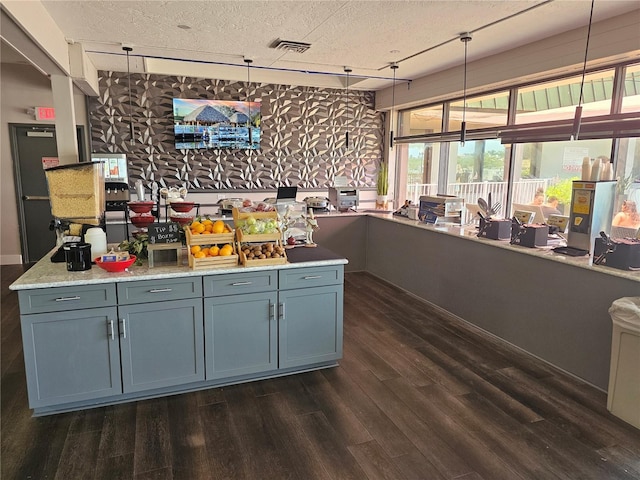 7150 N Tamiami Trl Unit C100, Sarasota, FL 34243 - kitchen featuring dark wood-type flooring, a textured ceiling, light countertops, and pendant lighting