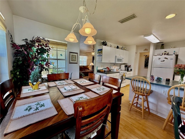 3828 6th Ave W, Palmetto, FL 34221 - dining room with light wood-style flooring and ceiling fan