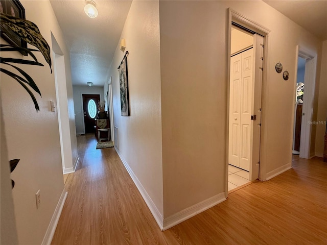 3828 6th Ave W, Palmetto, FL 34221 - hall featuring light wood-type flooring and baseboards