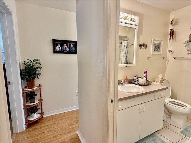 3828 6th Ave W, Palmetto, FL 34221 - bathroom featuring vanity, wood finished floors, toilet, and baseboards