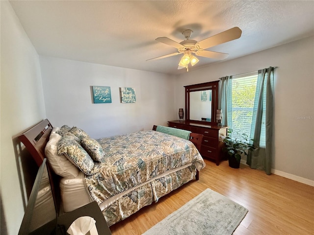 3828 6th Ave W, Palmetto, FL 34221 - bedroom with wood finished floors, a ceiling fan, and baseboards