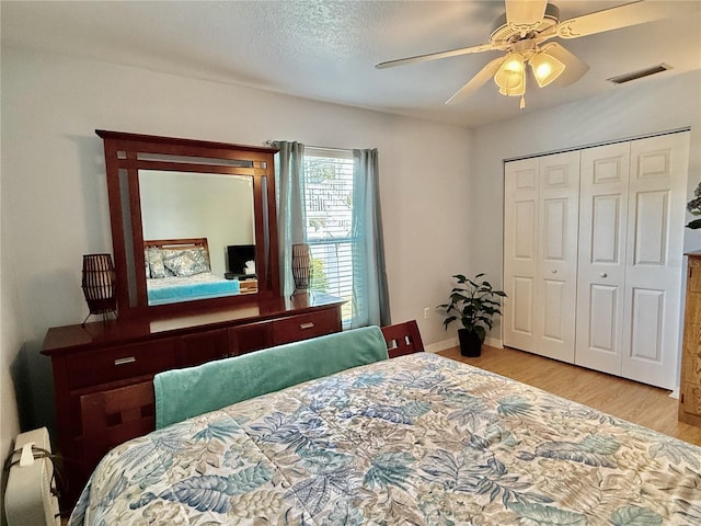 3828 6th Ave W, Palmetto, FL 34221 - bedroom featuring wood finished floors, a ceiling fan, a closet, baseboards, and a textured ceiling