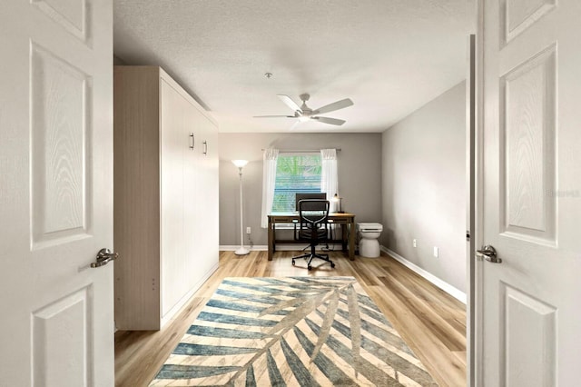 5624 Palmer Cir Unit 206, Bradenton, FL 34211 - office space with light wood finished floors, a ceiling fan, and a textured ceiling