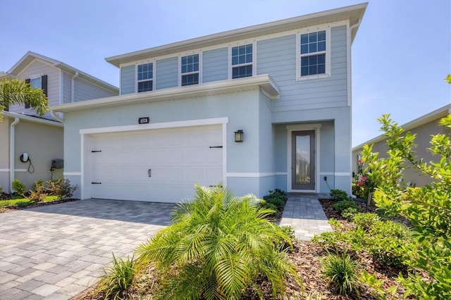 4524 Pippin Ln, Lakewood Ranch, FL 34211 - traditional home with stucco siding, a garage, and decorative driveway
