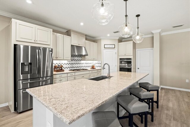 8272 Summer Night Rd, Sarasota, FL 34241 - kitchen featuring stainless steel appliances, a sink, under cabinet range hood, light wood-style flooring, and baseboards