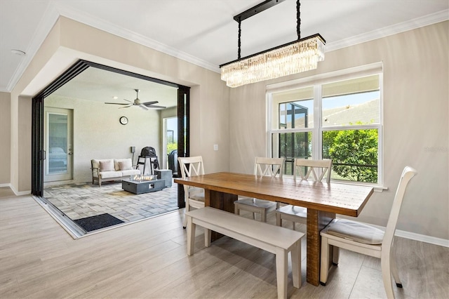 8272 Summer Night Rd, Sarasota, FL 34241 - dining area featuring crown molding, a chandelier, light wood-style flooring, and baseboards