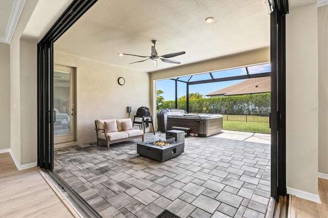 8272 Summer Night Rd, Sarasota, FL 34241 - view of patio / terrace with a hot tub, glass enclosure, a ceiling fan, and an outdoor fire pit