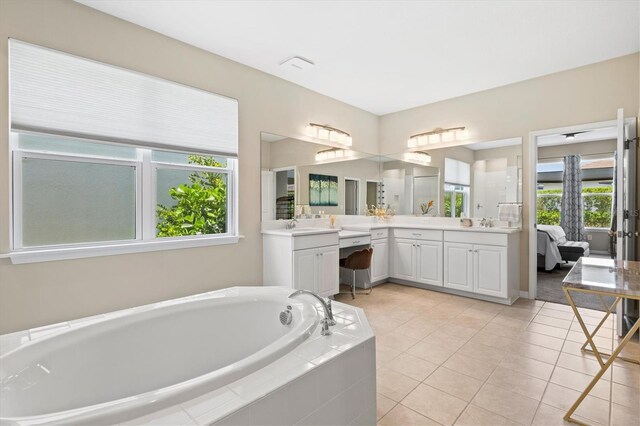 8272 Summer Night Rd, Sarasota, FL 34241 - bathroom with vanity, a bath, healthy amount of natural light, and tile patterned floors