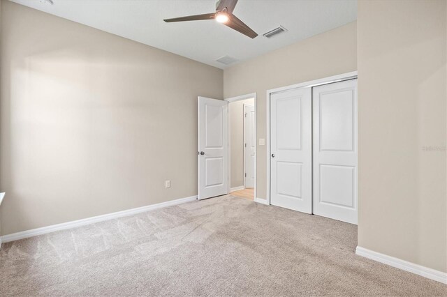 8272 Summer Night Rd, Sarasota, FL 34241 - unfurnished bedroom with light colored carpet, a closet, baseboards, and a ceiling fan