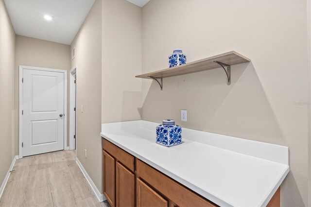 8272 Summer Night Rd, Sarasota, FL 34241 - laundry area featuring light wood-style floors, baseboards, and recessed lighting