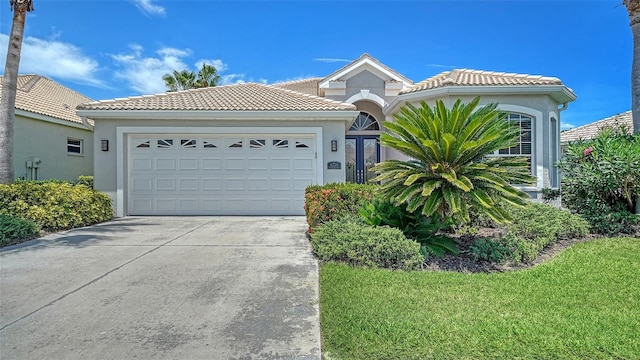 4220 Miriana Way, Sarasota, FL 34233 - view of front of property featuring concrete driveway, stucco siding, an attached garage, and a tile roof