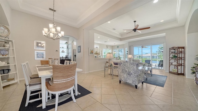 4220 Miriana Way, Sarasota, FL 34233 - dining area with a raised ceiling, healthy amount of natural light, a ceiling fan, arched walkways, and crown molding