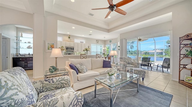4220 Miriana Way, Sarasota, FL 34233 - living area featuring ceiling fan, arched walkways, light tile patterned flooring, a raised ceiling, and recessed lighting