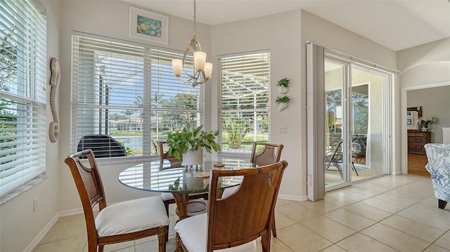 4220 Miriana Way, Sarasota, FL 34233 - dining area featuring a chandelier, light tile patterned flooring, plenty of natural light, and baseboards
