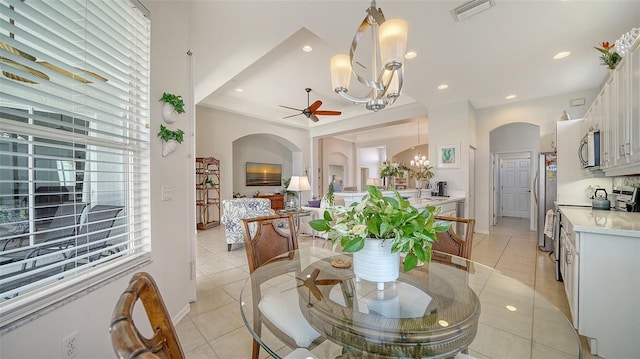 4220 Miriana Way, Sarasota, FL 34233 - dining space featuring a ceiling fan, arched walkways, a chandelier, light tile patterned flooring, and recessed lighting