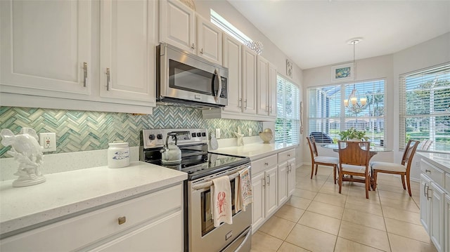 4220 Miriana Way, Sarasota, FL 34233 - kitchen featuring appliances with stainless steel finishes, tasteful backsplash, and white cabinetry