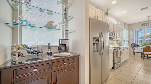 4220 Miriana Way, Sarasota, FL 34233 - kitchen featuring appliances with stainless steel finishes, light tile patterned floors, recessed lighting, white cabinets, and pendant lighting
