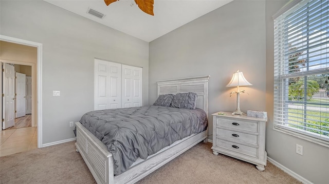 4220 Miriana Way, Sarasota, FL 34233 - bedroom with light carpet, a towering ceiling, baseboards, a closet, and a ceiling fan