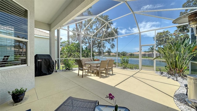 4220 Miriana Way, Sarasota, FL 34233 - view of patio / terrace with a water view, outdoor dining area, and glass enclosure