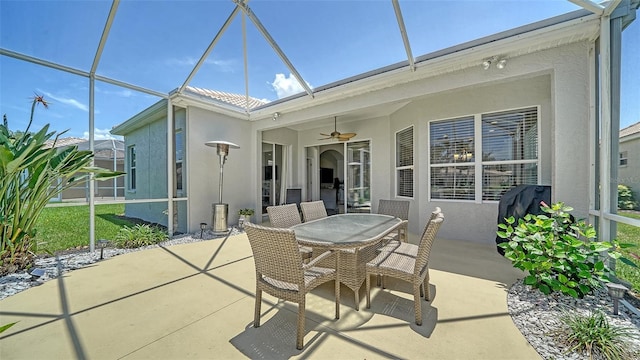 4220 Miriana Way, Sarasota, FL 34233 - view of patio / terrace featuring a ceiling fan, outdoor dining space, and glass enclosure