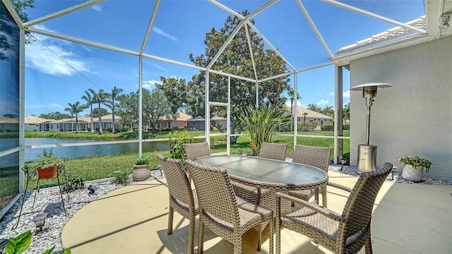 4220 Miriana Way, Sarasota, FL 34233 - view of patio with a water view, glass enclosure, and outdoor dining space