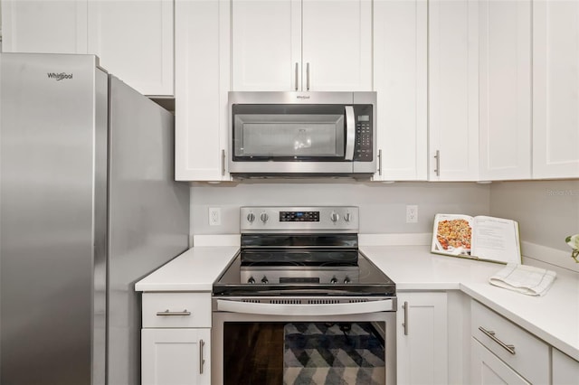 1040 Hope St, Venice, FL 34285 - kitchen with stainless steel appliances, light countertops, and white cabinetry