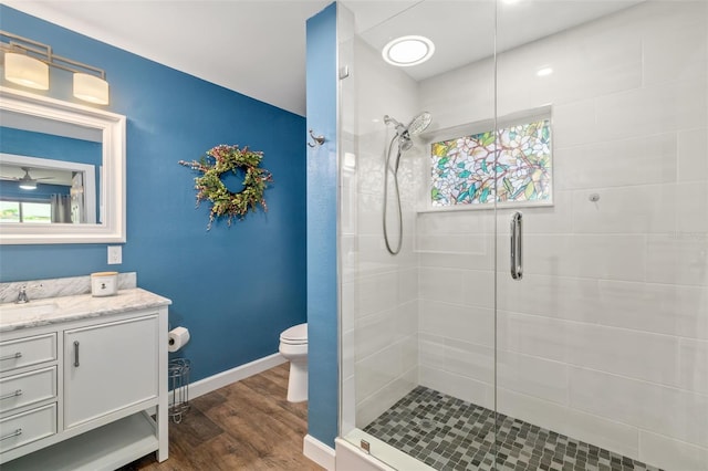 1040 Hope St, Venice, FL 34285 - bathroom featuring a stall shower, vanity, wood finished floors, toilet, and baseboards