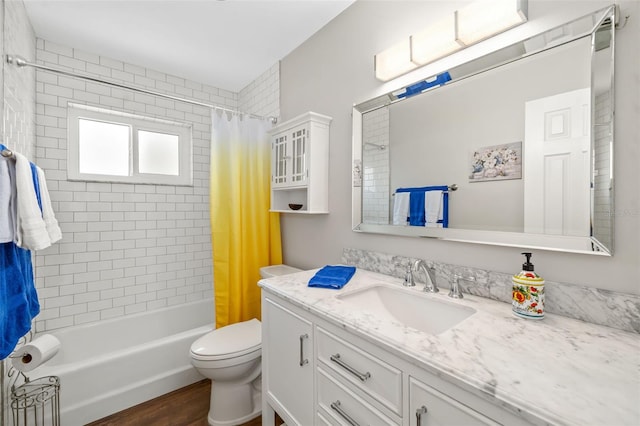 1040 Hope St, Venice, FL 34285 - full bath featuring vanity, toilet, shower / bath combo with shower curtain, and wood finished floors