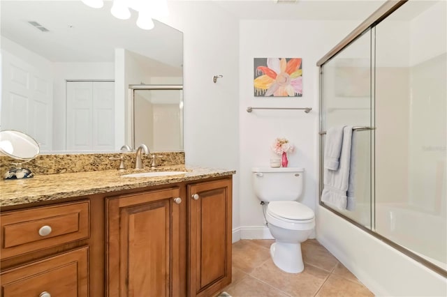 5401 Bentgrass Dr Unit 1-113, Sarasota, FL 34235 - bathroom with toilet, vanity, tile patterned floors, shower / bath combination with glass door, and baseboards