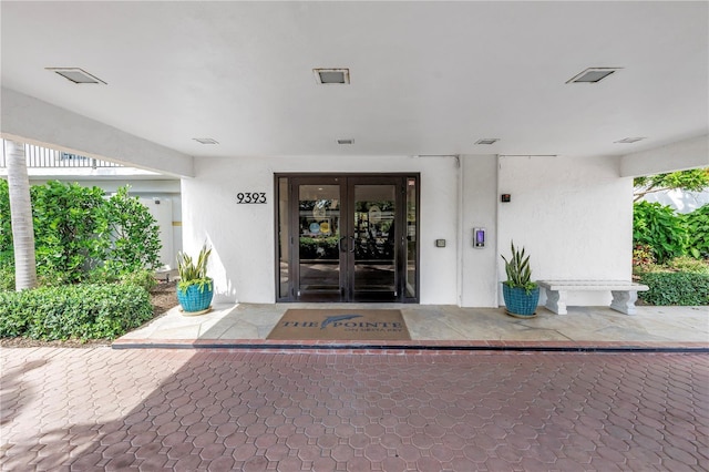 9393 Midnight Pass Rd Unit 603, Sarasota, FL 34242 - doorway to property featuring french doors and stucco siding