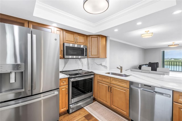 9393 Midnight Pass Rd Unit 603, Sarasota, FL 34242 - kitchen featuring appliances with stainless steel finishes, a sink, crown molding, light wood finished floors, and recessed lighting