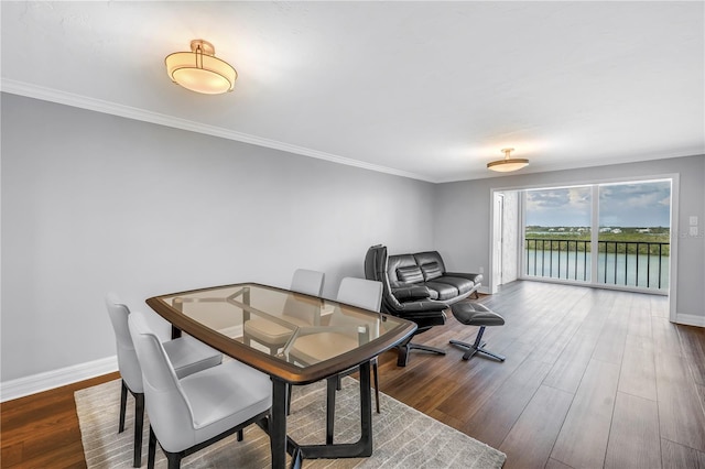 9393 Midnight Pass Rd Unit 603, Sarasota, FL 34242 - dining space with baseboards, ornamental molding, and wood finished floors