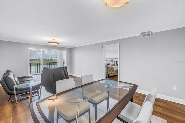 9393 Midnight Pass Rd Unit 603, Sarasota, FL 34242 - dining area featuring wood finished floors, ornamental molding, and baseboards