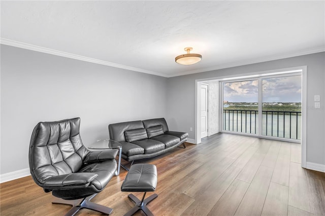9393 Midnight Pass Rd Unit 603, Sarasota, FL 34242 - living area featuring baseboards, wood finished floors, crown molding, and a water view