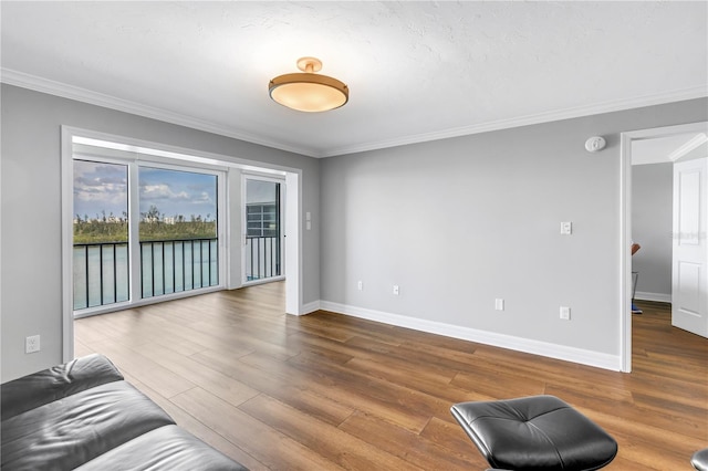 9393 Midnight Pass Rd Unit 603, Sarasota, FL 34242 - unfurnished living room with wood finished floors, ornamental molding, and baseboards