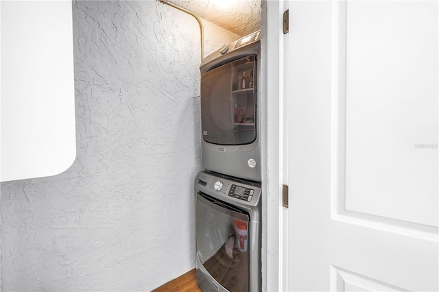 9393 Midnight Pass Rd Unit 603, Sarasota, FL 34242 - laundry area featuring stacked washer and clothes dryer and a textured wall