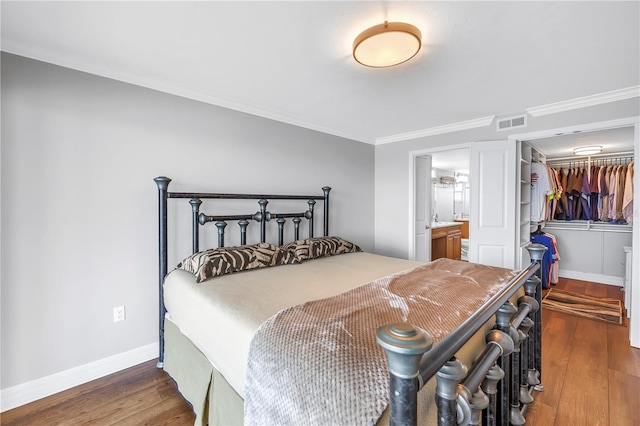 9393 Midnight Pass Rd Unit 603, Sarasota, FL 34242 - bedroom with wood finished floors, crown molding, baseboards, and ensuite bath