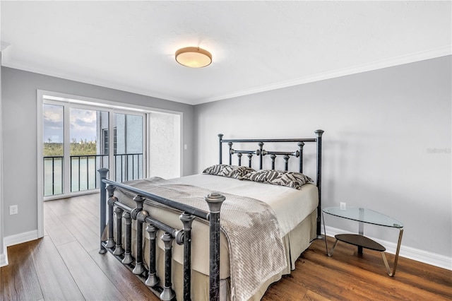 9393 Midnight Pass Rd Unit 603, Sarasota, FL 34242 - bedroom featuring baseboards, crown molding, wood finished floors, and access to exterior