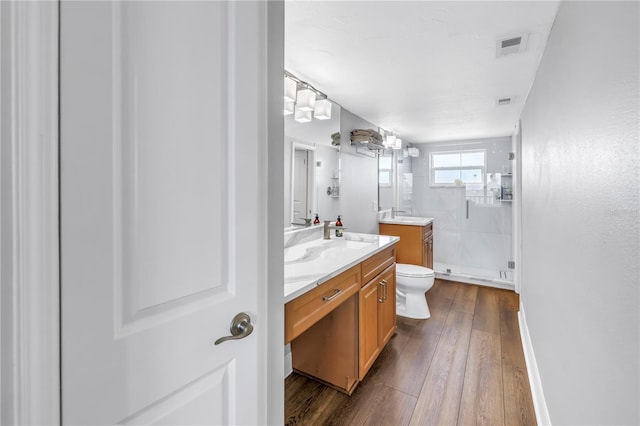 9393 Midnight Pass Rd Unit 603, Sarasota, FL 34242 - full bath featuring vanity, a stall shower, hardwood / wood-style floors, and toilet
