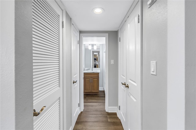 9393 Midnight Pass Rd Unit 603, Sarasota, FL 34242 - corridor featuring dark wood finished floors, baseboards, and a sink