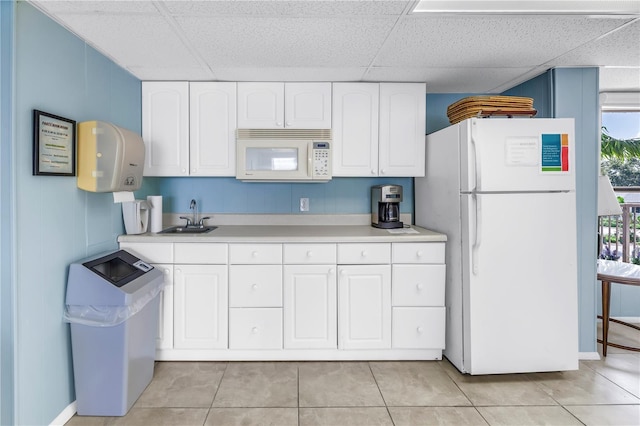 9393 Midnight Pass Rd Unit 603, Sarasota, FL 34242 - kitchen with white appliances, a paneled ceiling, a sink, light countertops, and white cabinetry