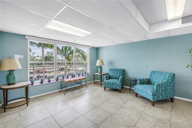 9393 Midnight Pass Rd Unit 603, Sarasota, FL 34242 - sitting room featuring tile patterned flooring, a paneled ceiling, and baseboards
