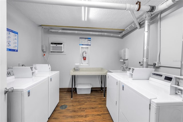 9393 Midnight Pass Rd Unit 603, Sarasota, FL 34242 - shared laundry with independent washer and dryer, a textured ceiling, dark wood-style flooring, and a wall unit AC