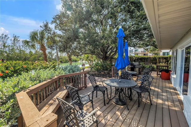9393 Midnight Pass Rd Unit 603, Sarasota, FL 34242 - wooden deck with outdoor dining area