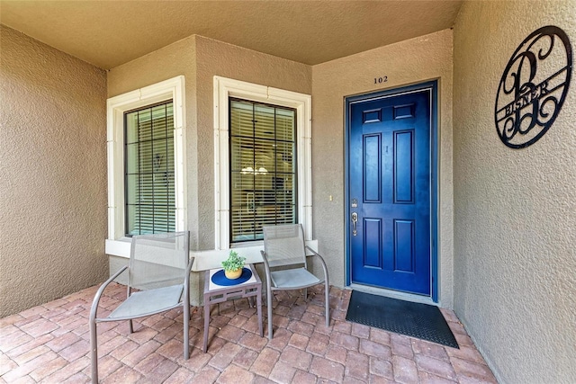 13711 Messina Loop Unit 102, Lakewood Ranch, FL 34211 - view of exterior entry featuring stucco siding and covered porch