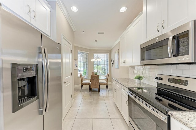 13711 Messina Loop Unit 102, Lakewood Ranch, FL 34211 - kitchen featuring appliances with stainless steel finishes, ornamental molding, a chandelier, white cabinets, and light tile patterned flooring